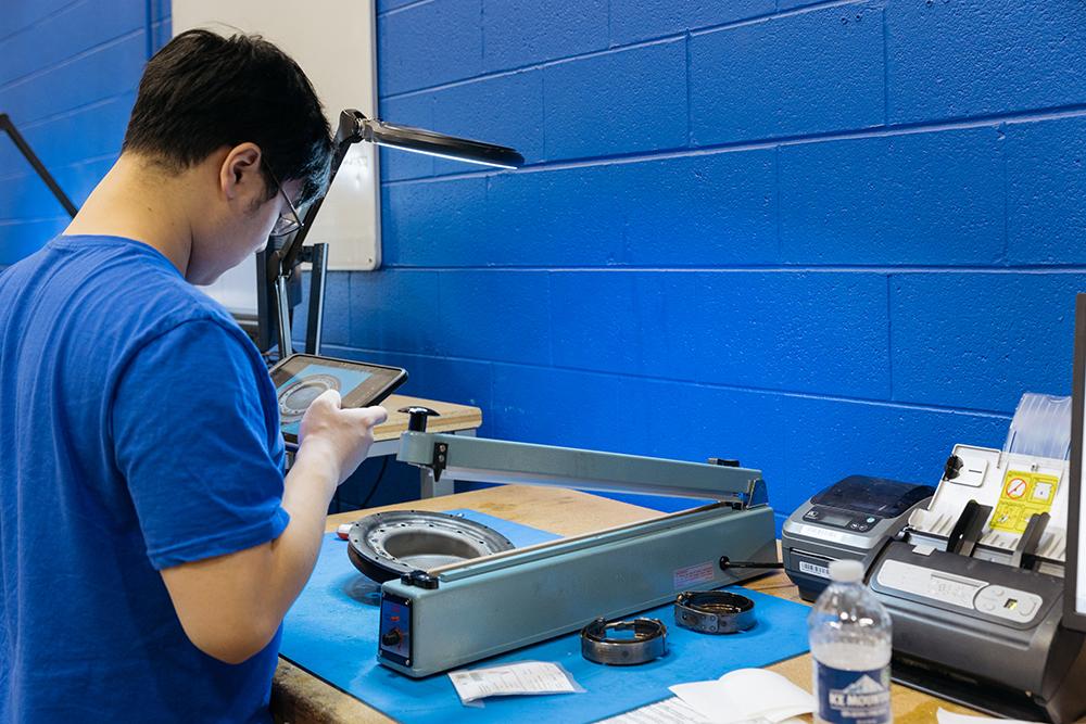 Technician takes photo of a part